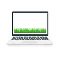 Laptop with green grass on white screen. Modern computer device with copy space. Royalty Free Stock Photo